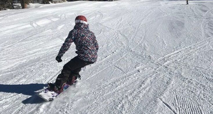 Women Snowboarder Heel Side Turn