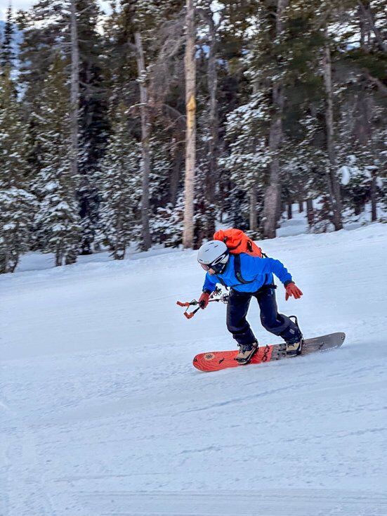 Man Snowboarding Wearing a Helmet