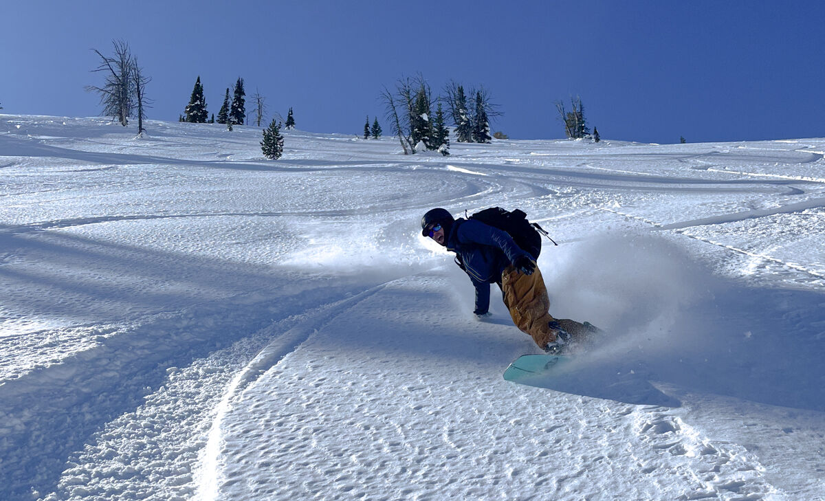 Man Ripping Healside Snowboard Turn