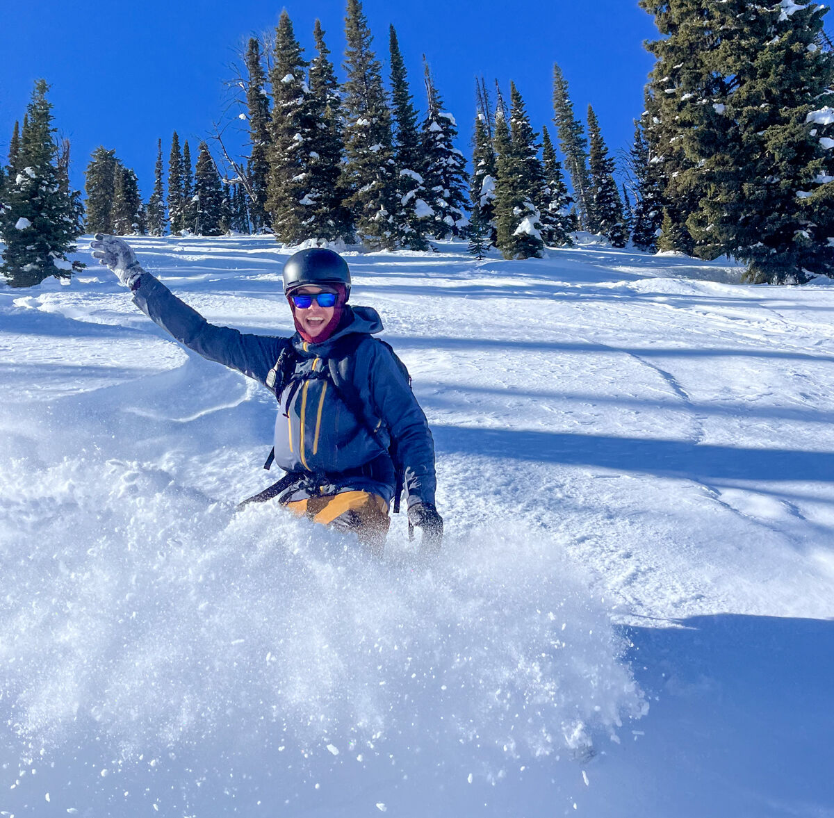 Man Snowbording Powder While Reviewing the Patagonia Stormstride Jacket