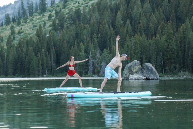 Couple Doing Yoga on Paddleboards