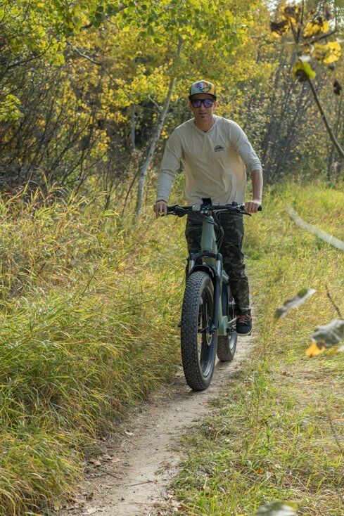 Man Standing Up While Riding E-Bike
