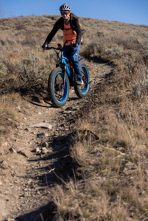 Man Riding E-Bike Down Windy Trail