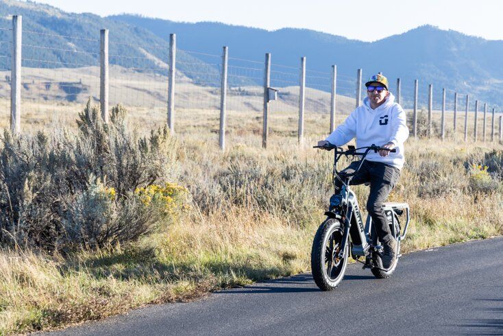 Man Riding E-Bike on Pathways