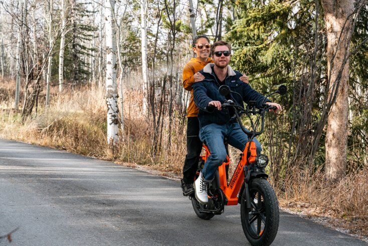 2 People Riding E-Bikes