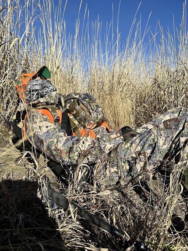 Man Taking a Break From Hunting While Wearing FORLOH Men's AllClima Soft Shell Jacket