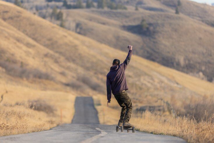 Man Surfing on E-Skateboard