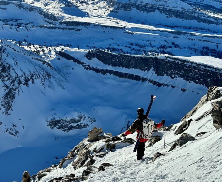 Mystery Ranch Scree 33L Backpack Review Man Skiing Deep in Backcountry Wearing Mystery Ranch Backpack