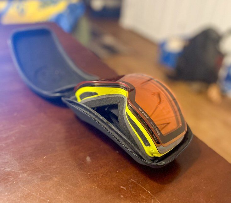 Goggles with the spare lens stacked on top of each other and held together by magnets. In this configuration, the spare lens and goggles fit in both the hard and soft case, but there is a risk of scratching the lens.