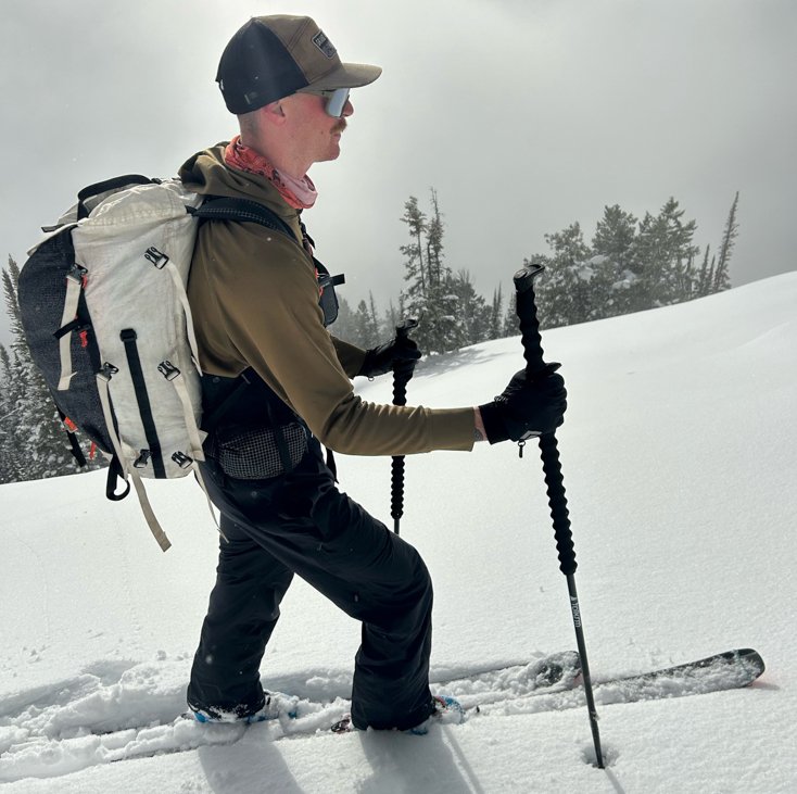 Man Ski Touring with Tall Poles