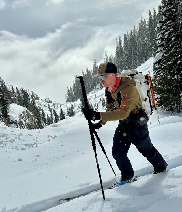 Man Ski Touring with Tall Poles