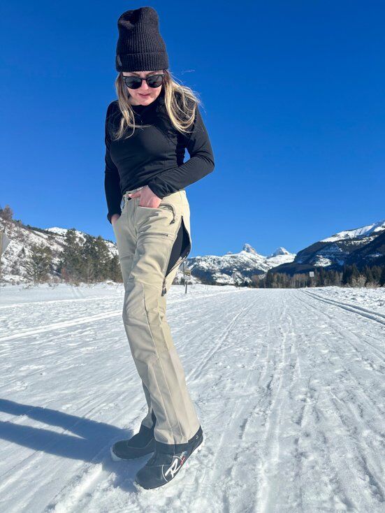 Women Wearing Ski Pants with Blue Sky