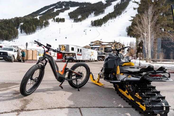E-Bike Next to Snowmobile