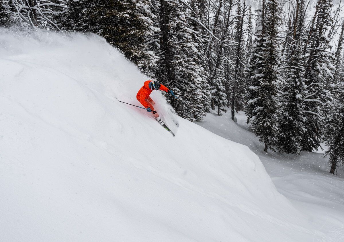 Man Slashing Turns on Skis