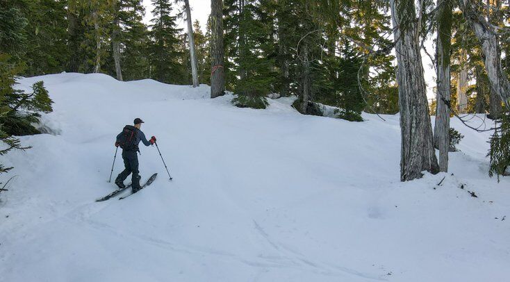 Man Splitboard Touring in the Backcountry