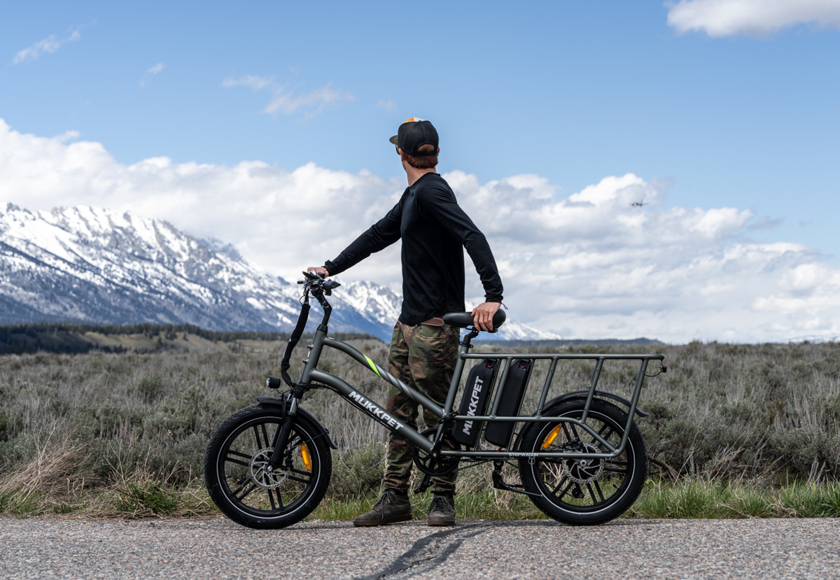 Man Standing Next to E-Bike with Step-Through Frame Design