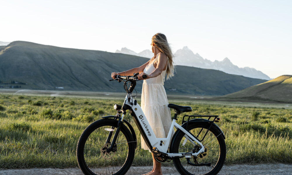 Women Modeling E-Bike the Tetons White Dress Bling Hair White Bicycle