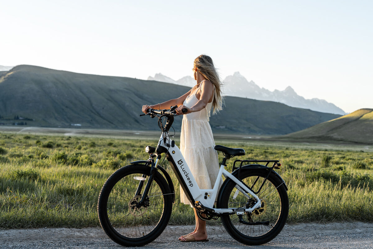 Women Modeling E-Bike the Tetons White Dress Bling Hair White Bicycle