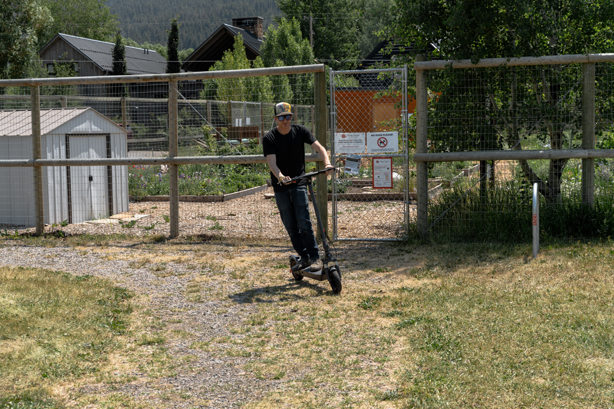 Man Riding Scooter on Dirt Gravel