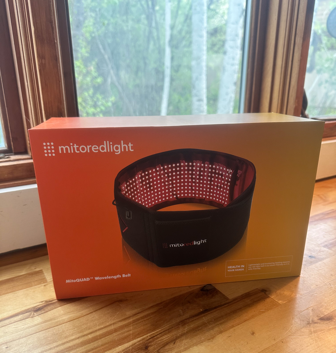 Retail packaging for the MitoQUAD Wavelength Belt red light therapy recovery system by Mito Red Light.