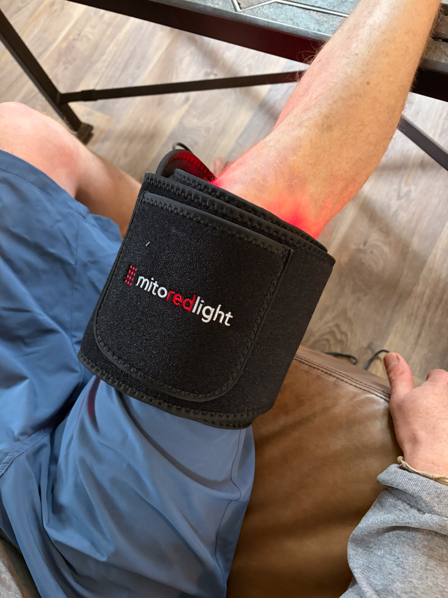 Mike Hardaker testing the MitoQUAD red light therapy belt on his knee during recovery after a mountain biking accident.