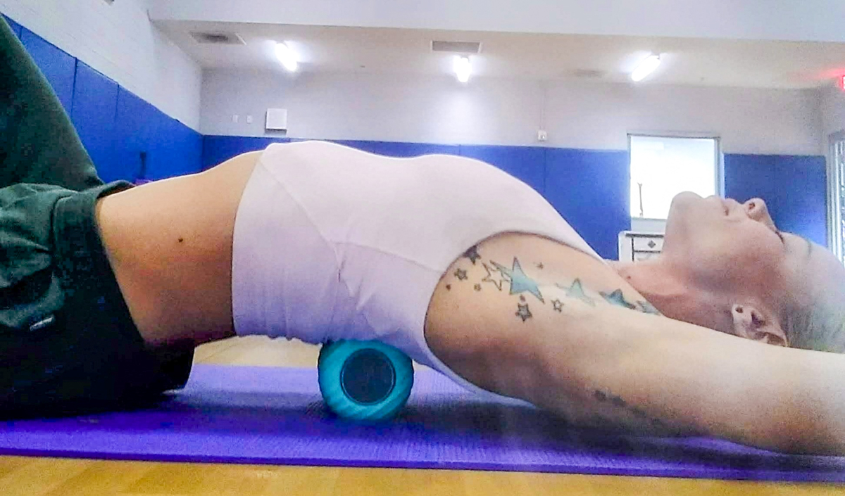 Woman Laying on Roller Massager
