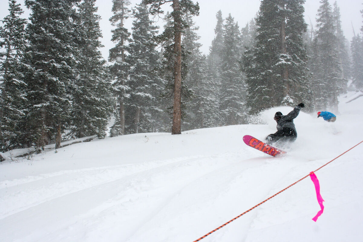 Snowboarders Riding Powder at Loveland Ski Area on a Snowy Day in Colorado