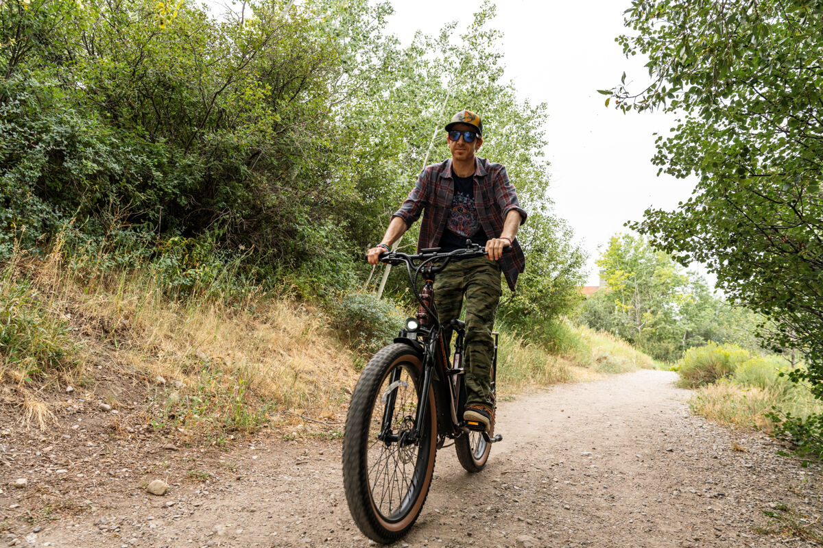 Man Riding E-Bike Down Dirt Road
