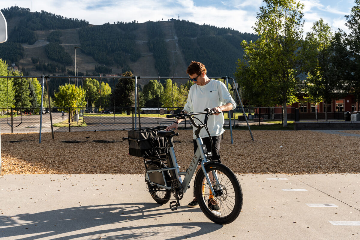 Man Standing Next to E-Bike