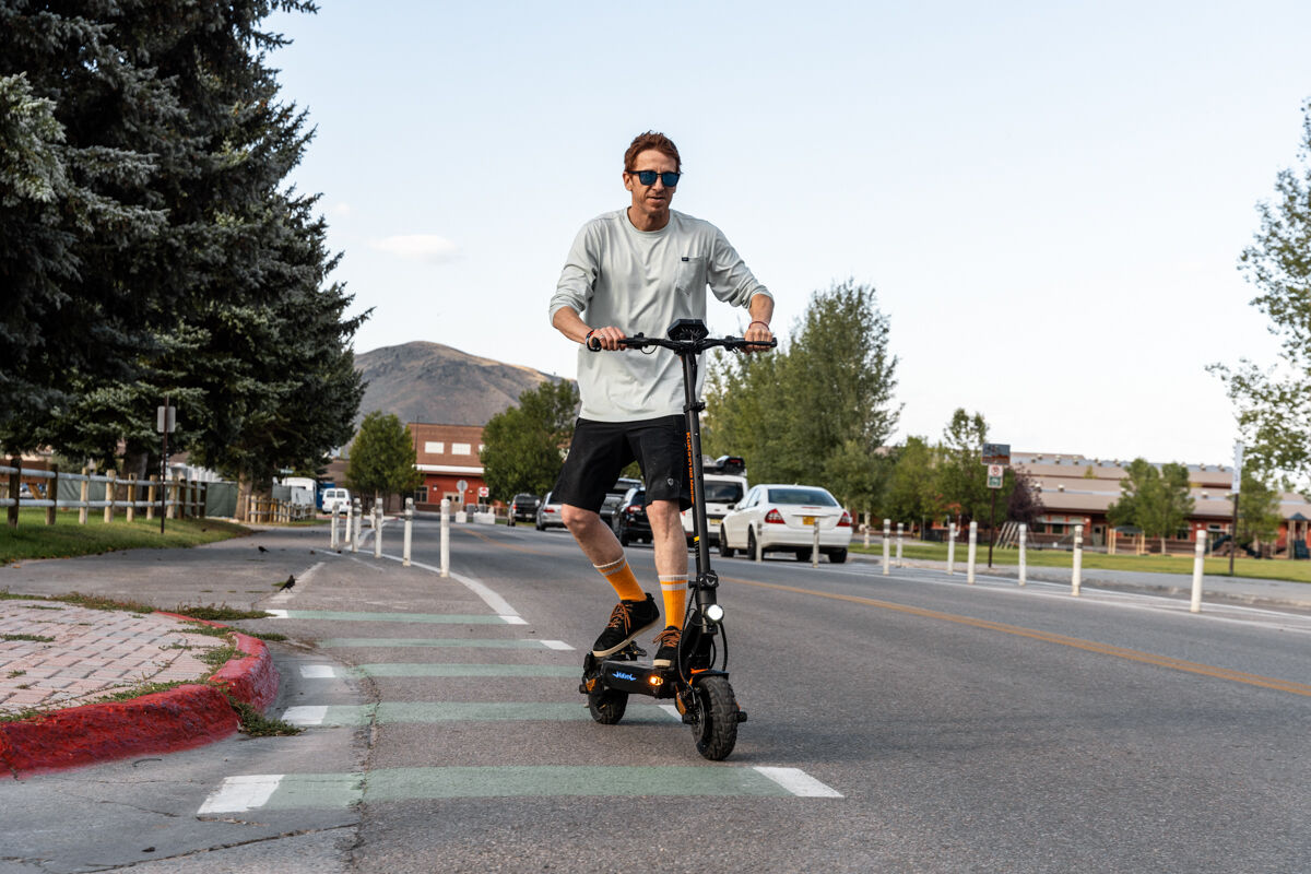 Man Riding E-Scooter