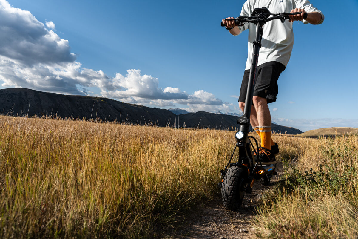 Man Riding E-Scooter on Dirt Trail