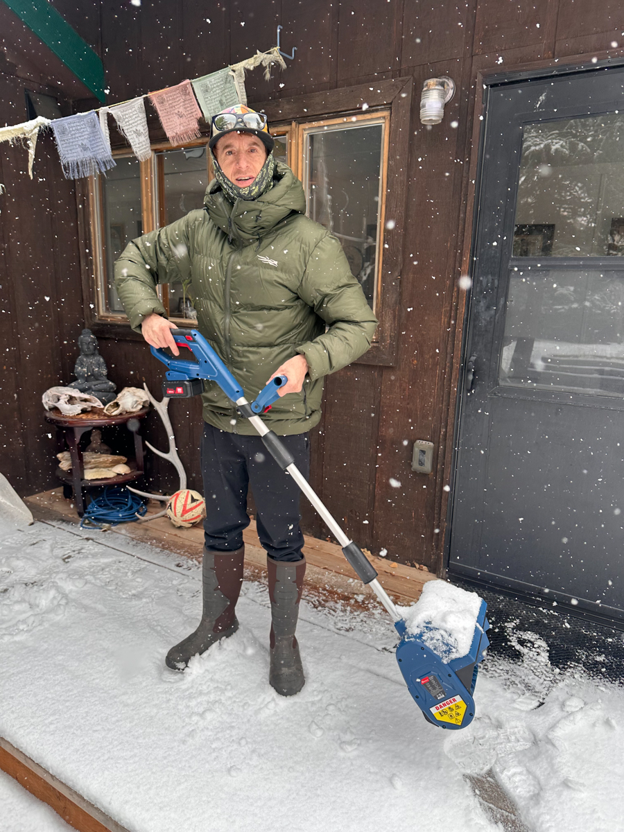Man Holding Cordless Snow Shovel