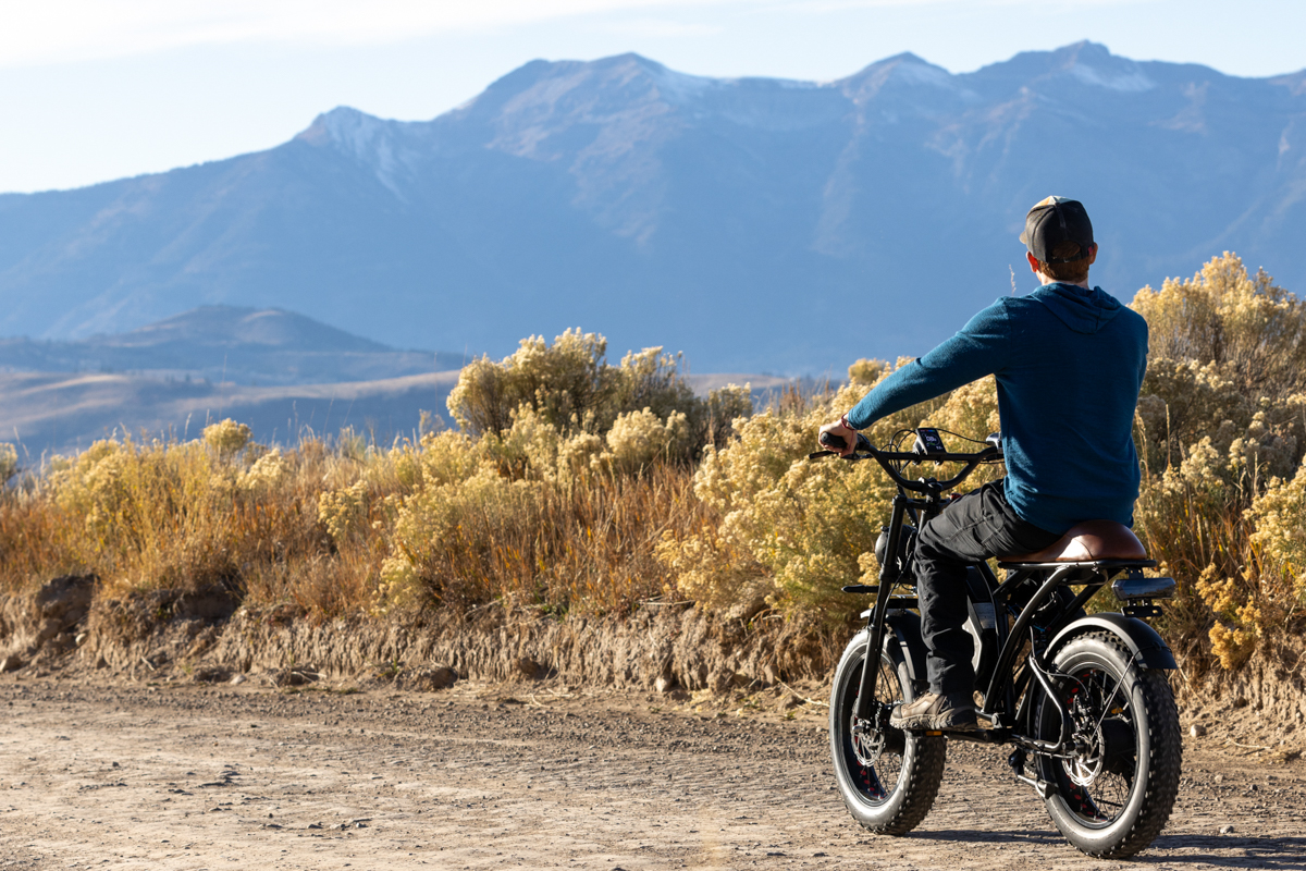 Man Riding Off into Sunset on E-Bike