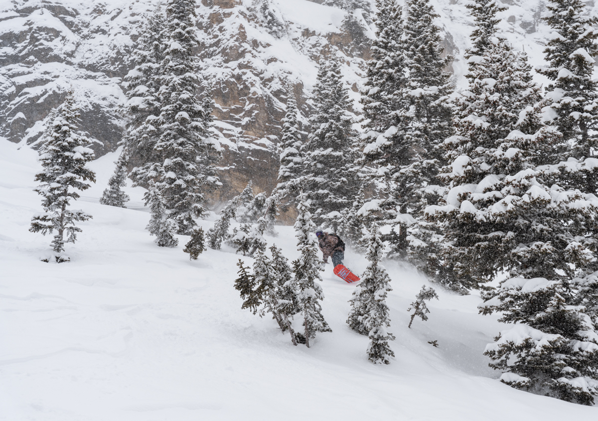 Man Riding Fast on Snowboard