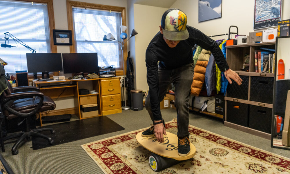 Man Riding Balance Board Getting into a tuck
