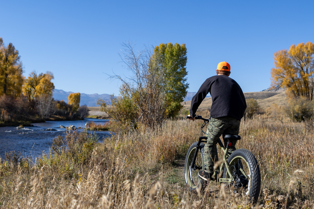 Man Riding E-Bike Orange Camo Hunting