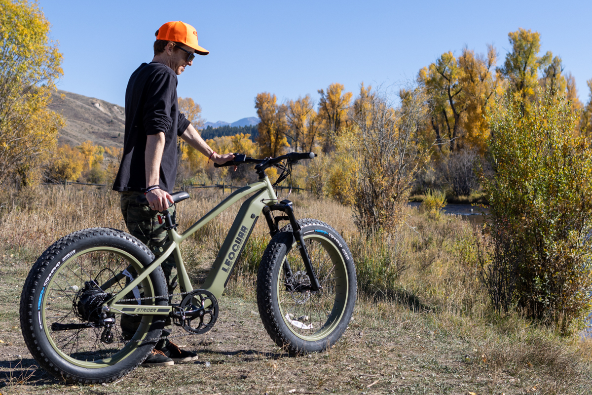 Man Standing Next to E-Bike