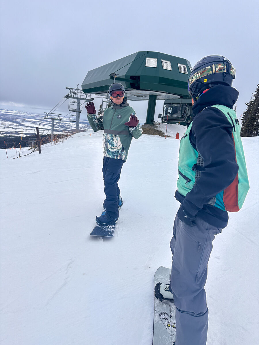 Man Waiting to Snowboard at Top of The Chairlift