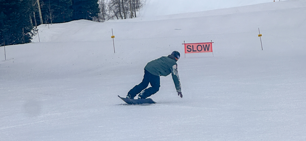 Man Snowboarding on Groomers