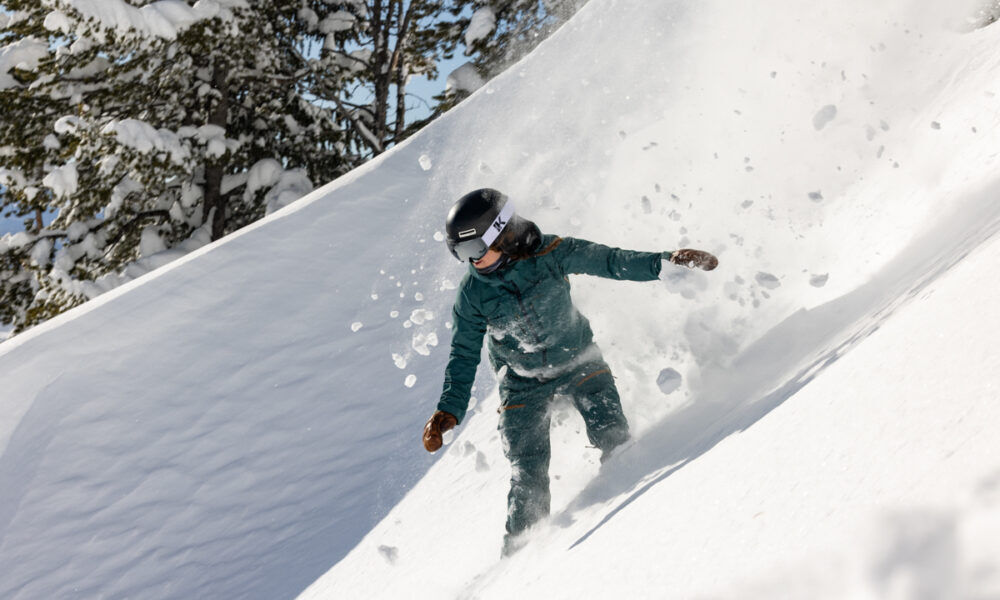 Innerking OTG Magnetic Ski Goggles Women Riding Powder on Snowboard in Green Outfit with InnerKing Goggles