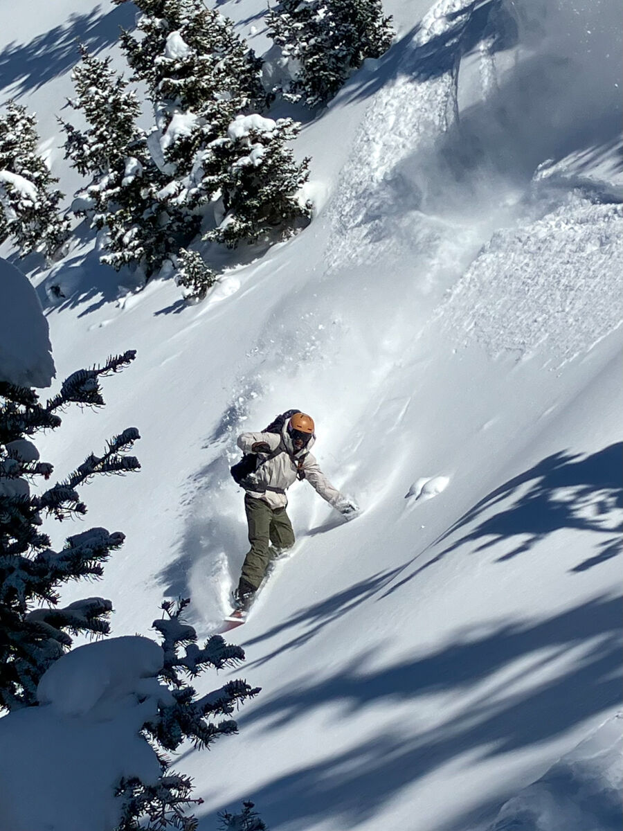 Man Snowboarding in White Nike ACG Jacket