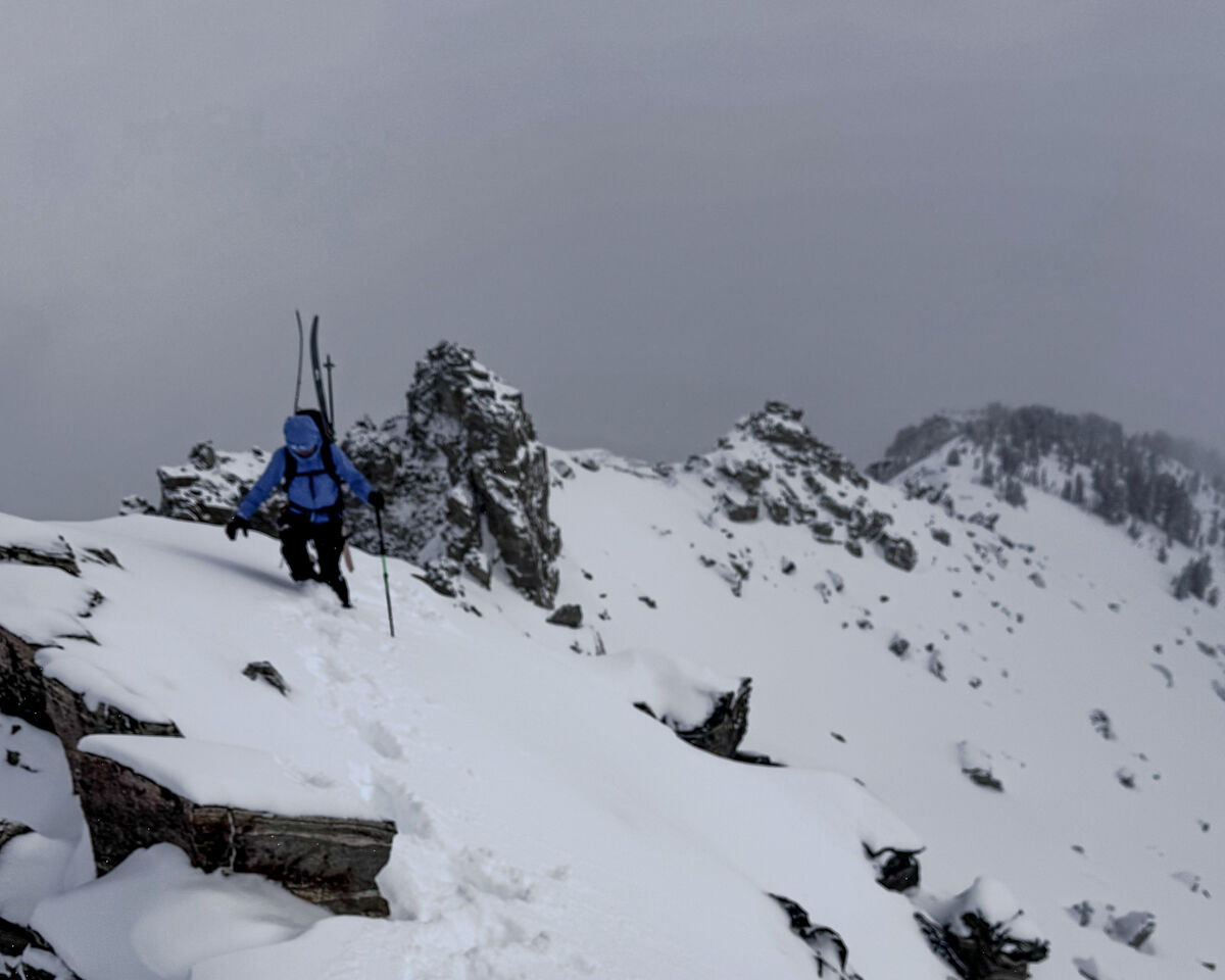 Women Climbing with Skis and Blue Jacket