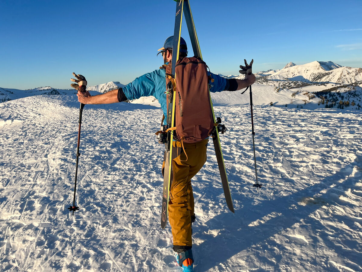 Man Wearing Backpack with Skis