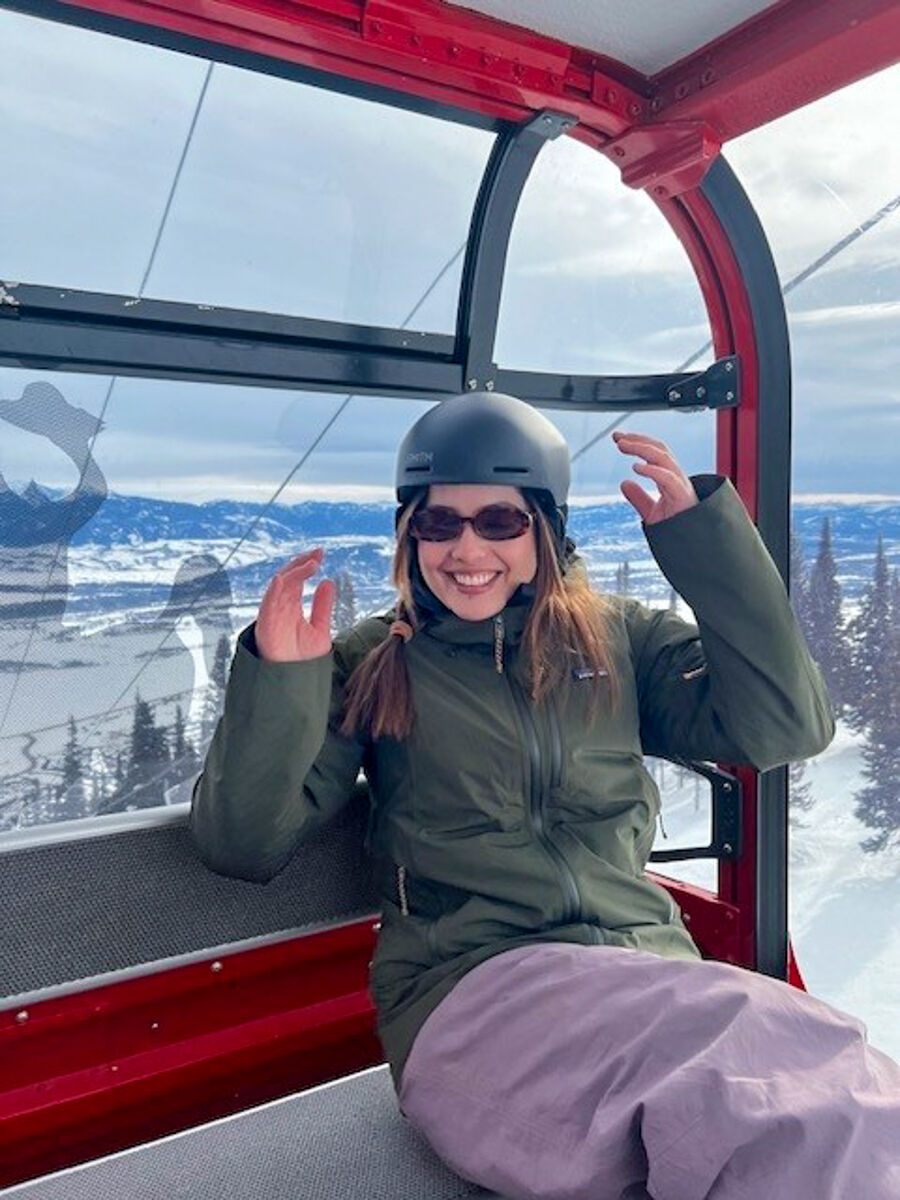 Women Sitting in Ski Gondola Wearing Green Patagonia Snow Jacket