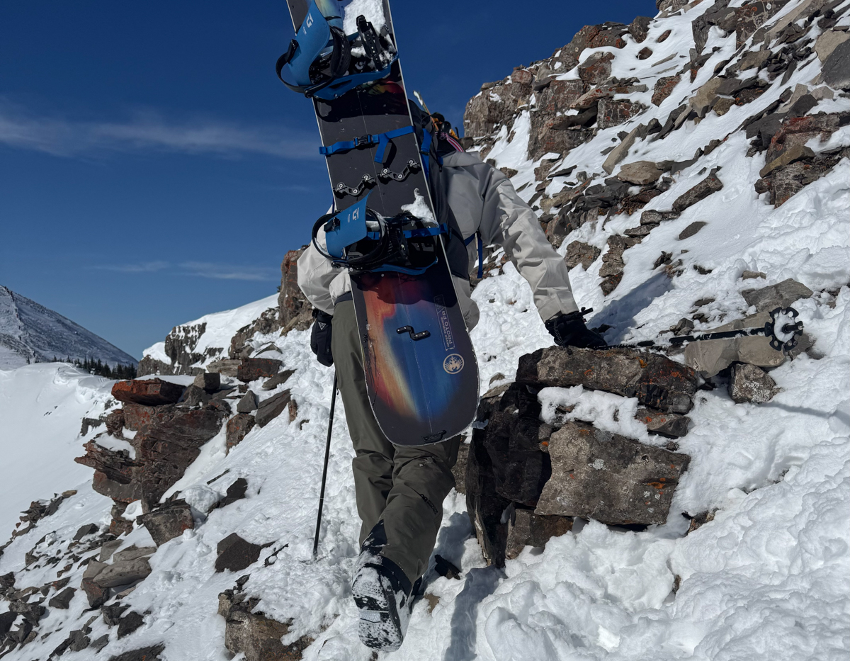 Man With Snowboard on Backpack