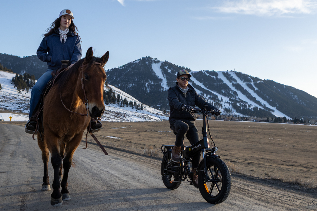 Mike Hardaker Riding E-Bike Next to Horses