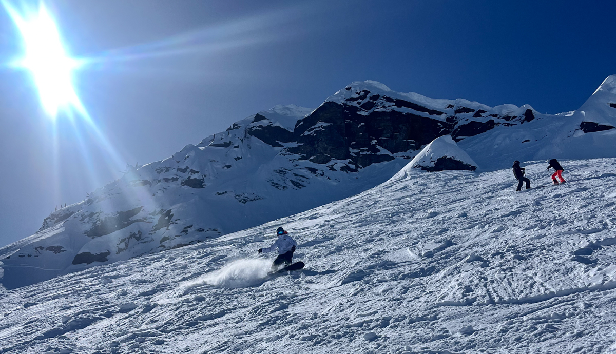 Man Snowboarding on Sunny Day
