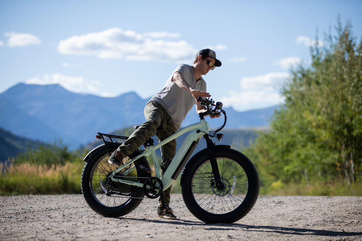 Man Getting on and Off E-Bike