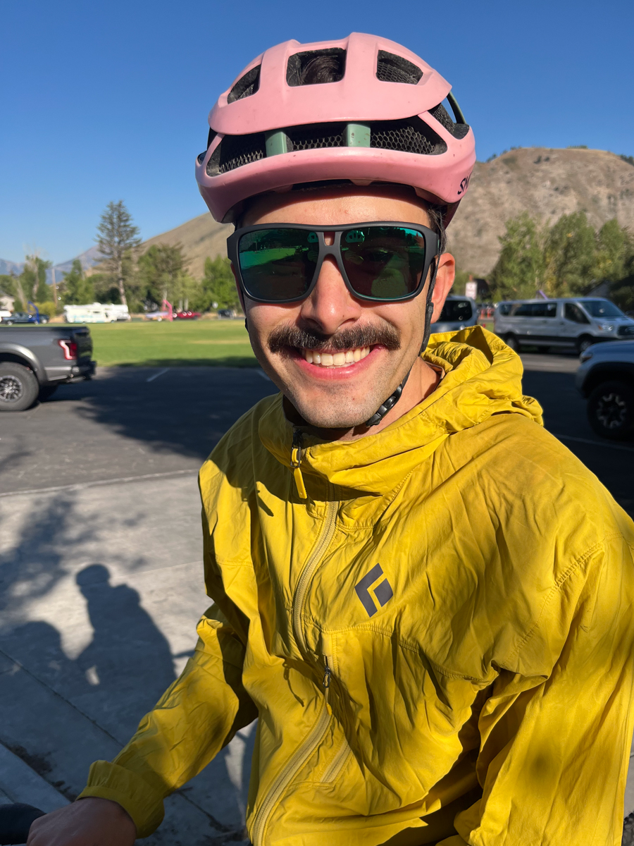 Man Wearing Dragon Sunglasses and Pink Helmet