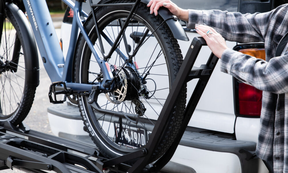 Kuat’s Piston ION 2 Rack Was Built With Heavy E-Bikes in Mind Women with E-Bike Rack and Fat Tire Bike